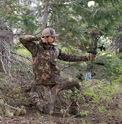 Person in camouflage aiming a compound bow in a forest.