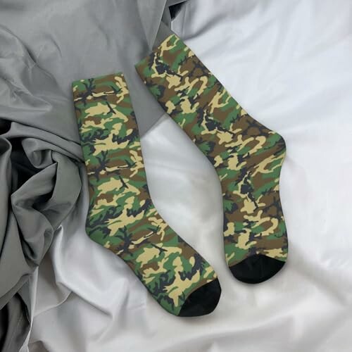 Camouflage pattern socks on gray fabric background