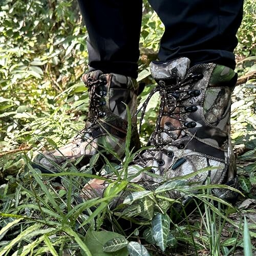 Person wearing camouflage hiking boots in forest