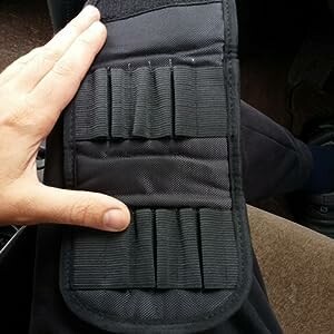 Hand holding a black pouch with elastic loops.