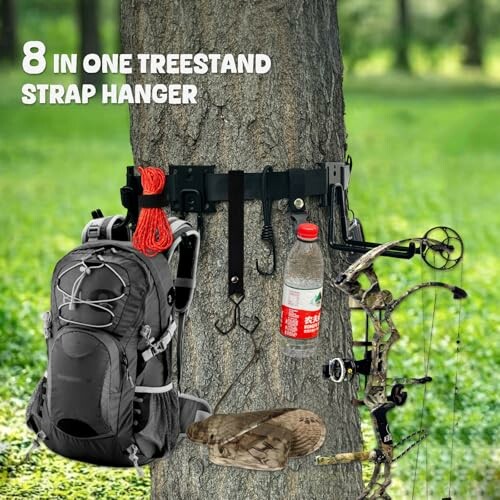 Tree with 8-in-1 treestand strap hanger holding backpack, bow, and other gear.